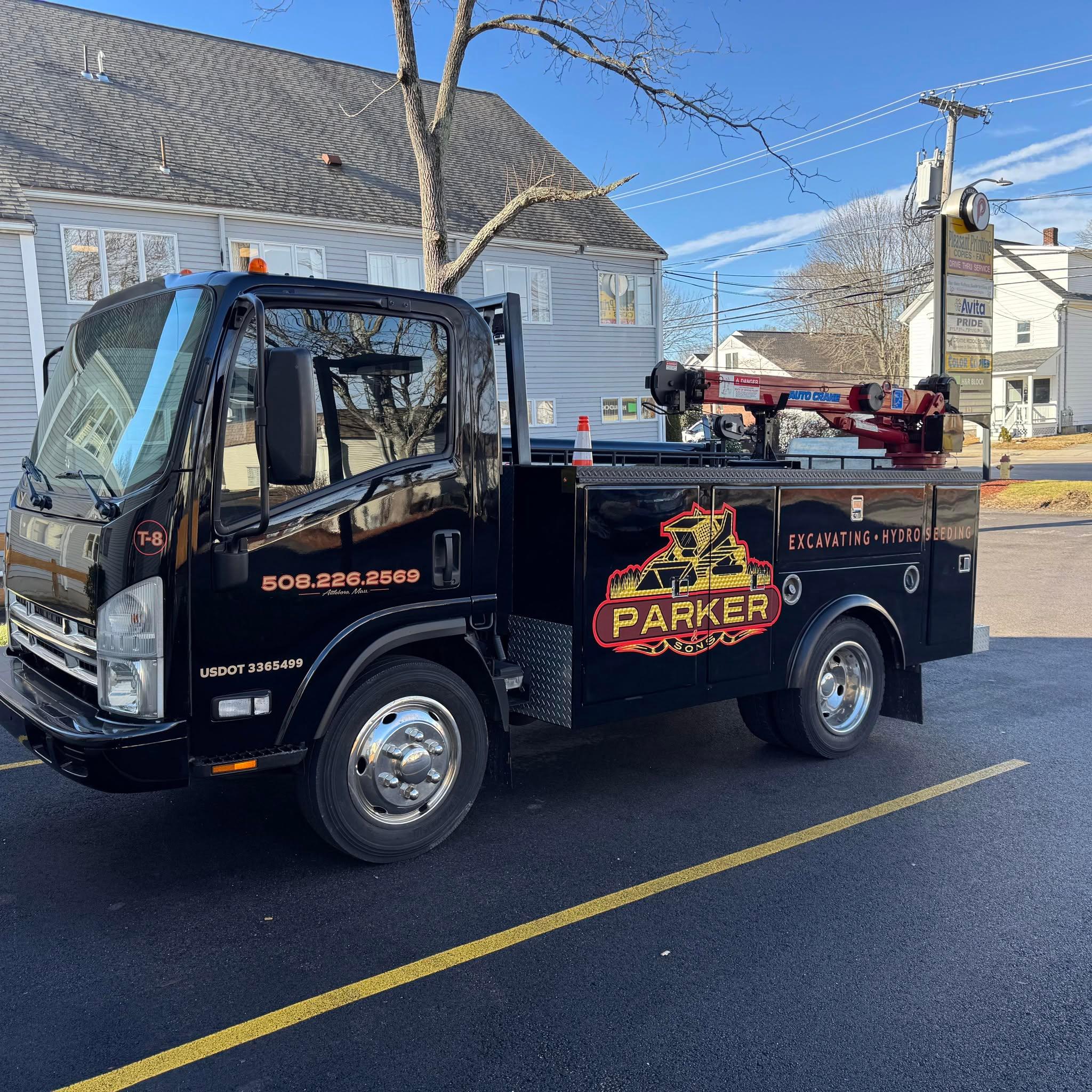 Black Parker and Sons service truck showing the company logo and contact number