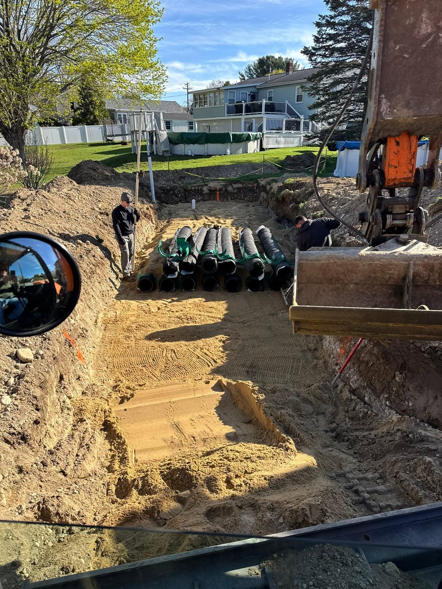 Septic chambers staged in an excavated residential work area
