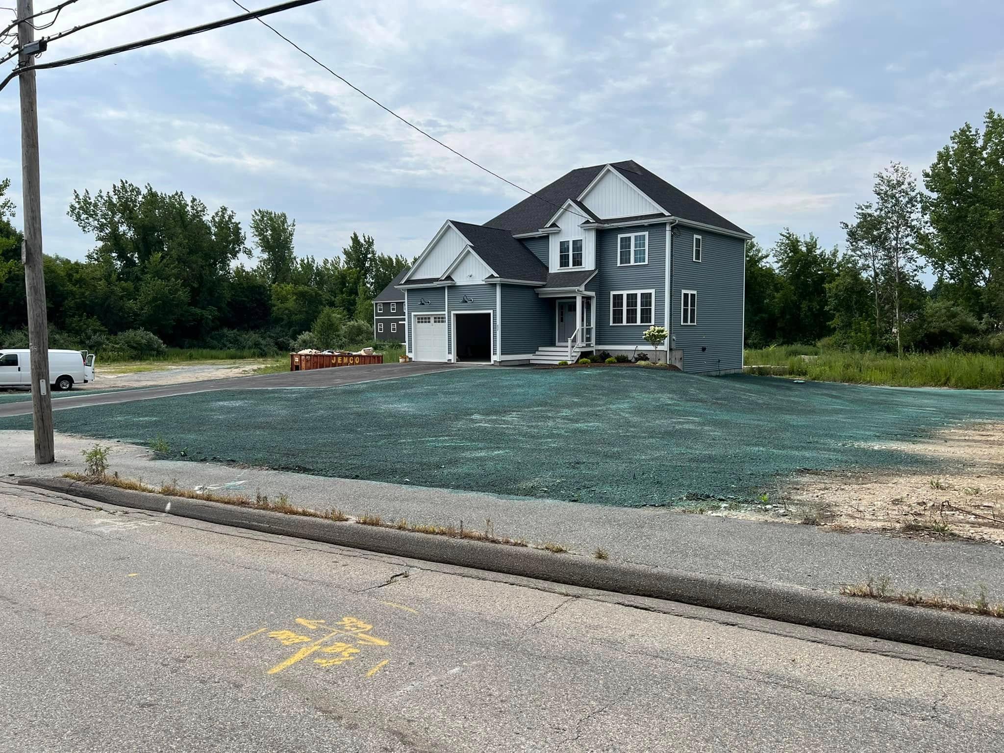 Hydroseed applied across the prepared lot of a newly built home
