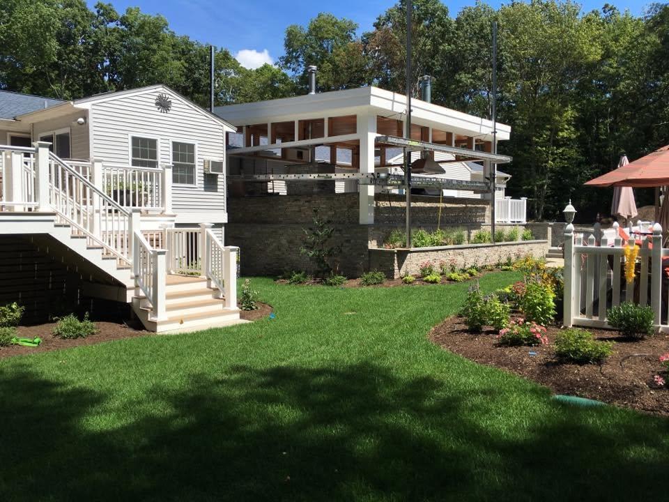 Established lawn and planting beds around a residential patio