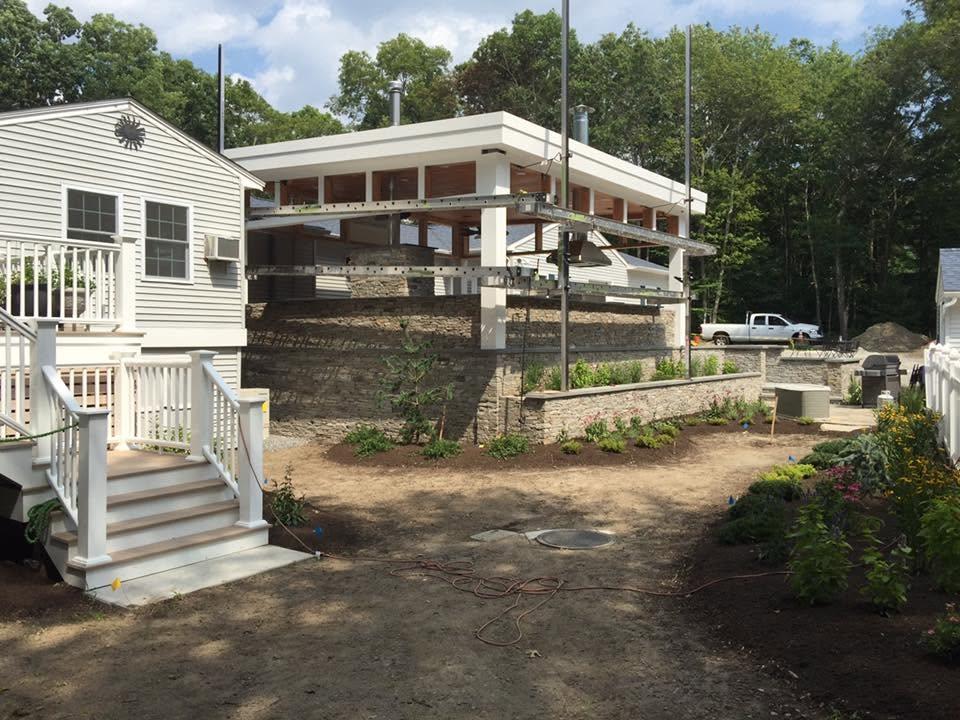 Residential patio property with prepared planting beds and unfinished ground