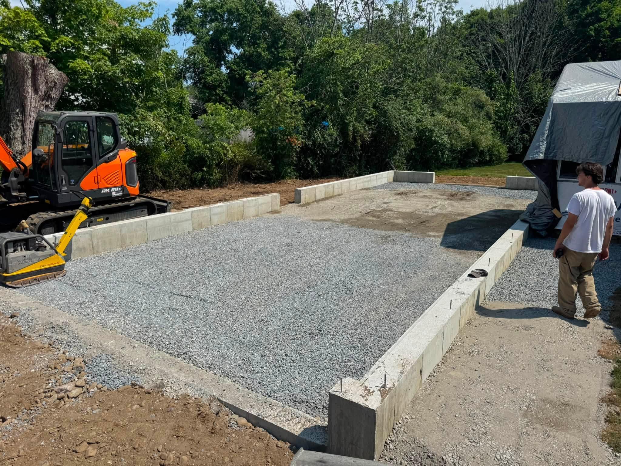 Compacted gravel base prepared inside the home-addition perimeter