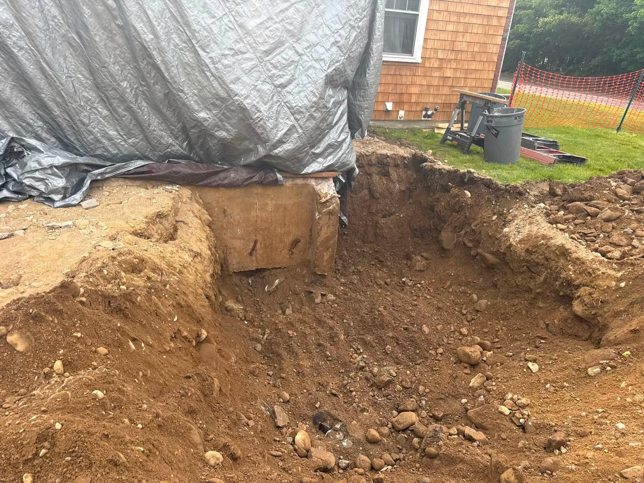 Open foundation excavation beside the existing home